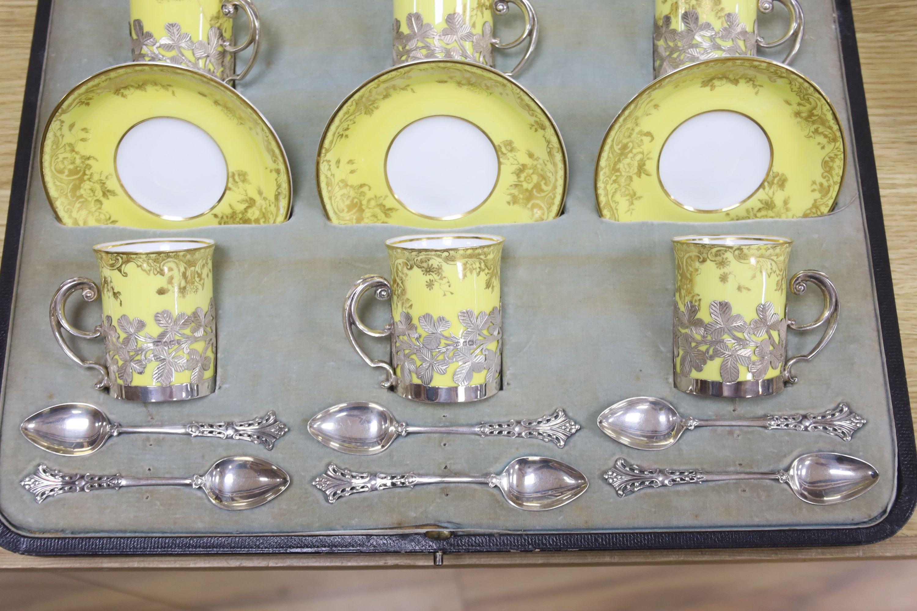 A cased Edwardian part silver mounted Crescent China tea set for six, including six silver teaspoons, Sheffield, 1905.